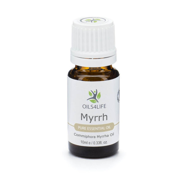 Myrrh Essential Oil bottle beside natural myrrh resin pieces on a white background