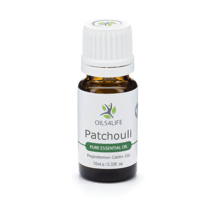 Patchouli Essential Oil bottle with dried patchouli leaves on white background